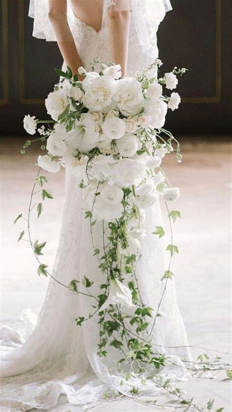 Your wedding bouquet could turn out to be one of the most gorgeous bouquets if you decide to use white pansies. #DiyWeddingFlowers | Cascading wedding bouquets, White ...