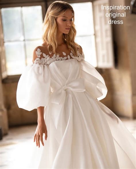 Beautiful wedding couple in the forest. Puffy sleeves white tulle A line wedding dress with bow ...