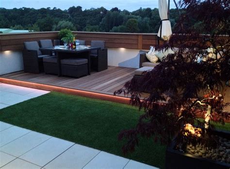 Modern garden designs draw on the simplicity of asian design practices. Early evening on roof terrace with LED lighting | Roof ...