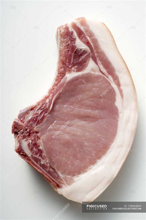 How do you identify thin pork chops at the grocery store? Raw pork chop — calorie, top view - Stock Photo | #149663844