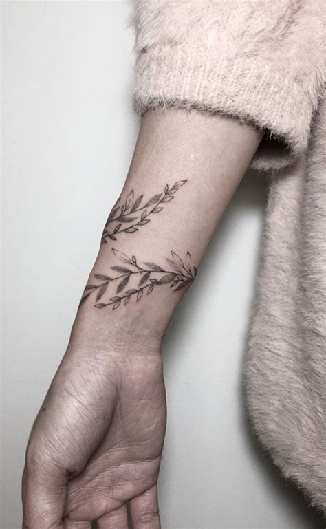 An olive branch on the outside of the wrist creates a beautiful line that mimics that of the area between the wrist and the hand. Pin by Kim Trowbridge on Tats ideas | Simple wrist tattoos ...