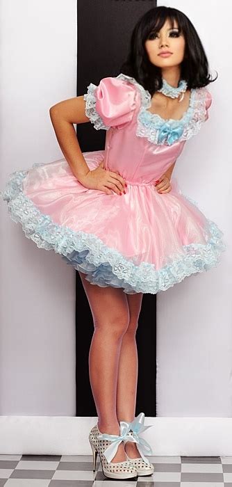 Young sissy crossdresser poses in a pink frilly dress for the camera. Felicia Sissy Dress