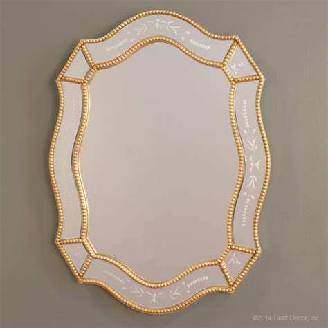 Crafted with a stunning gold finish, this timeless mirror features a classic style frame, with an ornate beaded detailing on the inner frame. ornate beaded mirror