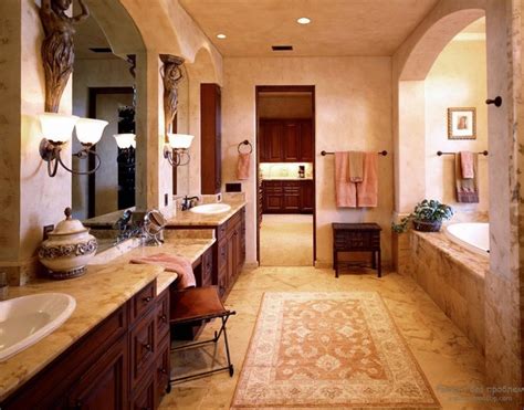 The rough brick wall and unfinished wood table of this space contrast with the smooth, geometrical look of the washbasin and mirror. 15 Astonishing Mediterranean Bathroom Designs