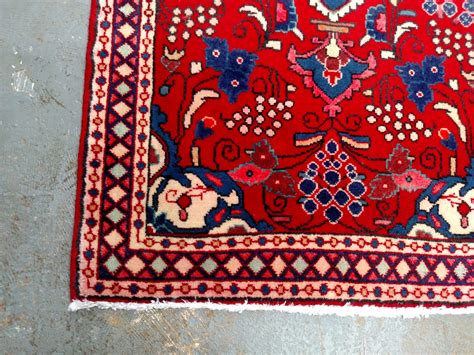 She had floor and wall tiles laid in different patterns and chose mossy green paint for the vanity. Red Sarouk Persian Rug Perfect for Entryway or Powder Room