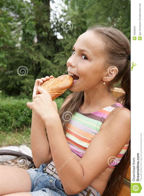 Maybe you would like to learn more about one of these? Preteen girl eats bread stock image. Image of portrait - 10229247