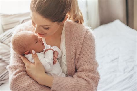 Once your baby is ready for a bath, you might use a plastic tub or the sink. Holding Newborn Baby at Home - Modern Homestead Mama