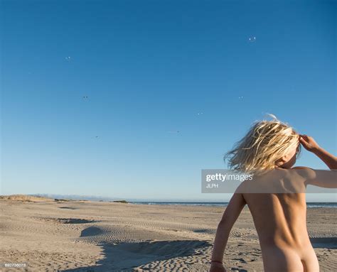 Check spelling or type a new query. Rear View Of Nude Boy On Beach Looking Away Foto de stock ...