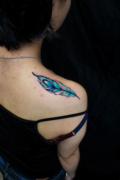 77 colorful rose tattoos spanning shoulder and arms. Blue peacock feather tattoo on shoulder | Blue rose ...