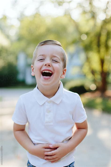 Boys standing in shower under umbrella. Portrait Of An Adorable Young Boy Laughing by Jakob ...