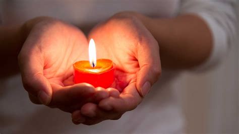 Someone is holding a candle. 6 Ways to Pray When You Feel Spiritually Stuck | Guideposts