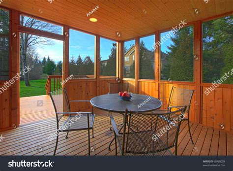 The total cost of the installation can range anywhere from just a couple hundred dollars for a diy project to several thousand for an. Covered Screen Porch With Dining Table Stock Photo ...