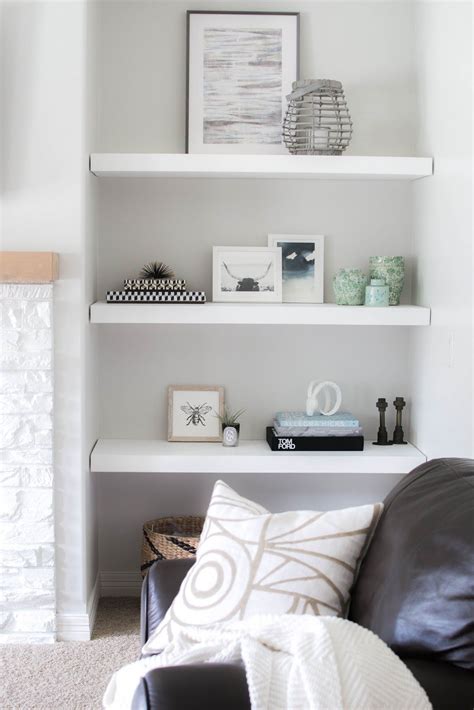 When the sofas and chairs are pushed up against all of the walls, it can give the illusion of the room feeling smaller, she advises. Styling Our New Floating Shelves | Floating shelves living room, Black sofa living room decor ...