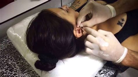 A surface bar follows the plane of skin, while a standard piercing is pierced through the plane. Tragus Piercing - YouTube