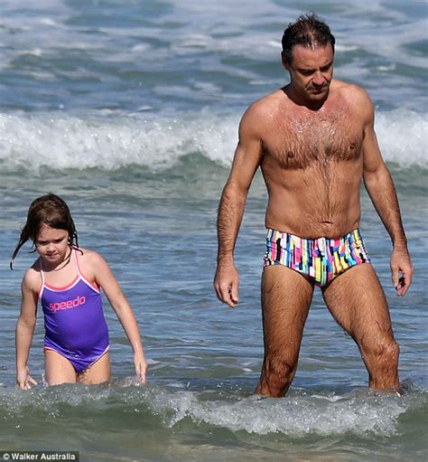 Andrew O'Keefe catches the eye as he hits Bondi beach with ...