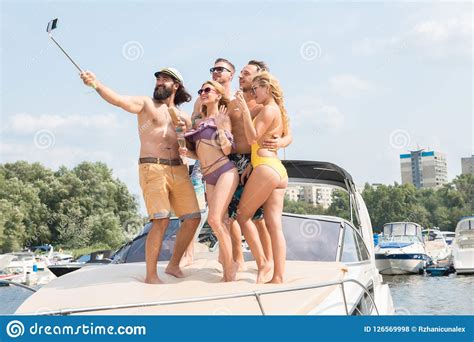 Those two guys were human too ya know? Three Young Guys With Two Girls Do Selfie On A Yacht Stock ...