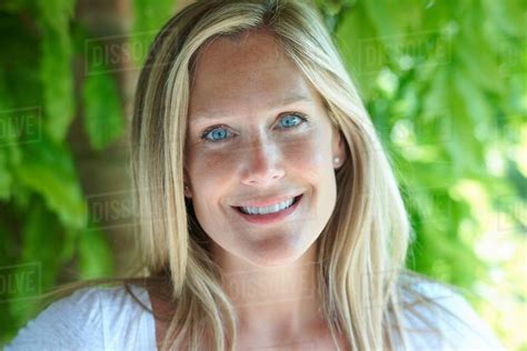 Portrait of mature woman with blonde hair and blue eyes - Stock Photo ...