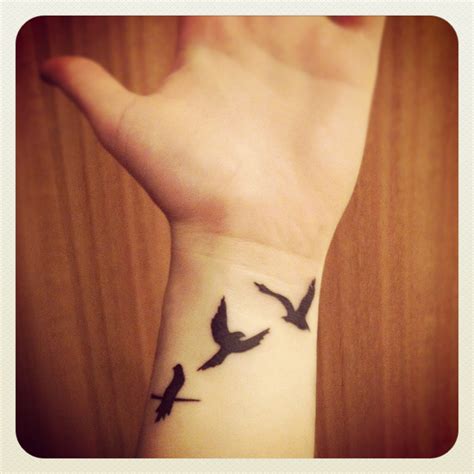 Another very popular bird tattoo design. flying away bird tattoo | Cool wrist tattoos, Small wrist ...