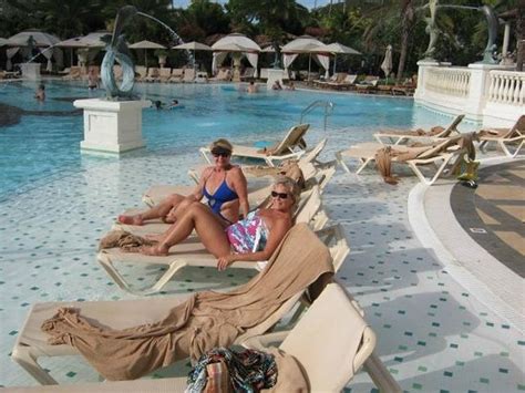 Someone whose job is to welcome guests to a hotel and provide them with information and other services. Wife at Pool - Picture of Sandals Grande Antigua Resort ...