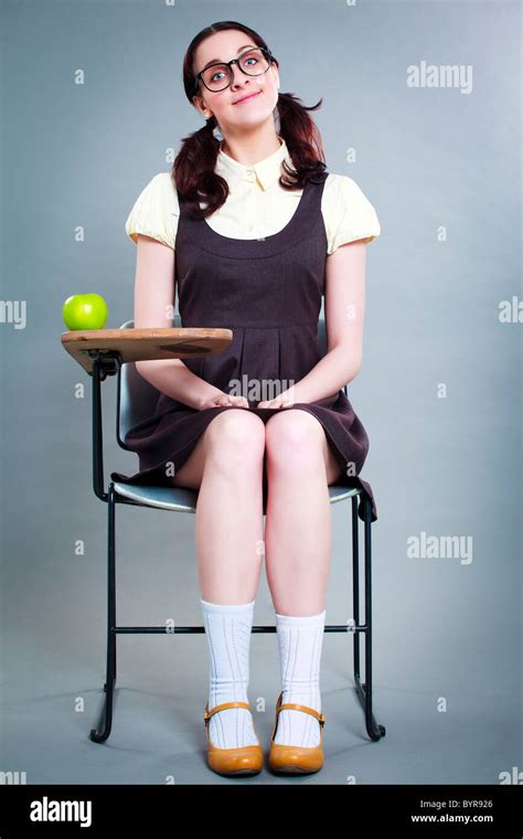 good geeky school girl quietly sits at desk Stock Photo - Alamy