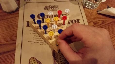 The triangular board has 15 holes in it, and the goal is to hop pegs over each other and into one of the holes until just one peg remains. Cracker Barrel Game - YouTube