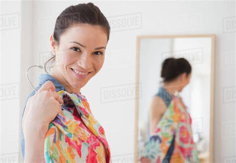 Caucasian woman trying on clothes in store - Stock Photo - Dissolve