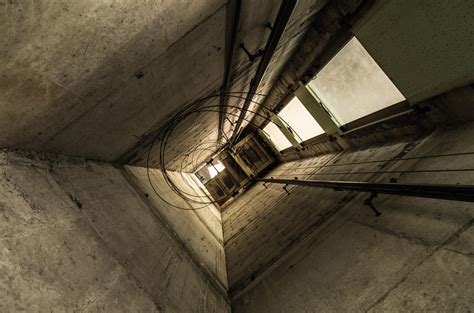 The elevator pit is the depression below the surface of the lowest landing that allows the elevator floor to be level with the floor of the lowest landing. abandoned elevator shaft : urbanexploration