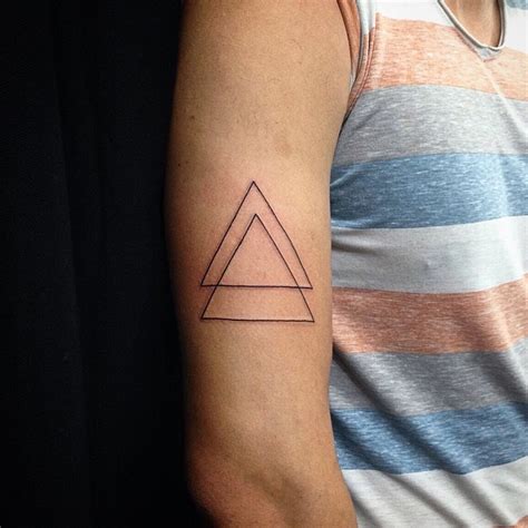 All admire dwayne johnson's impressive and intricate sleeve tattoo. Two connected black ink thin line triangles tattoo on ...