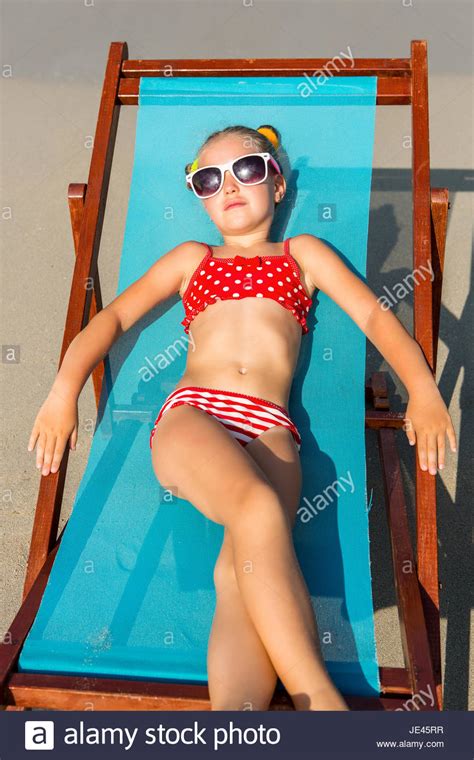 Women want camel toe now?! Cute little girl in red swimsuit and sunglasses enjoying ...