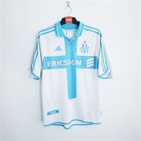 Known as sporting club, us phocéenne and football club de marseille in the first five years after its foundation, the club adopted the name olympique de marseille in 1899 in honour of the anniversary of marseille's founding by greeks from phocaea some 25 centuries earlier. Olympique Marseille home football shirt 2000/01 | Classic ...