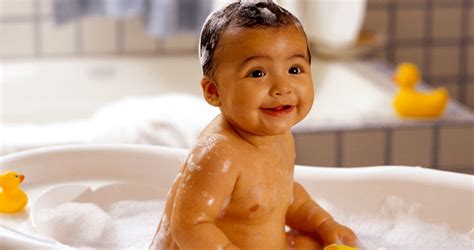 Once your baby is ready for a bath, you might use a plastic tub or the sink. Cute Baby Smiling In Bath Tub