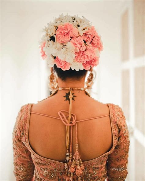 Neat edges and hair accessories take one of the. 21 Floral Bouquet Bun Hairstyles for Brides who love being Extra! | ShaadiSaga | Bridal hairdo ...
