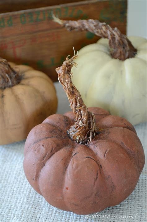 Lining the streets at the produce stand, filling the front aisles of the grocery stores, and scattered around porches and storefronts as decorations. DIY Pumpkins with Realistic Looking Stems | ANDERSON+GRANT
