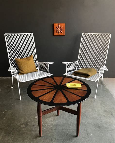 Edmonton stackable black metal frame stationary conversation chair (s) with mesh seat seat. Frank Rohloff resin and walnut table and VKG expanded metal lounge chairs. | Metal lounge chairs ...