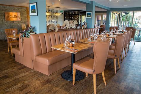 Reds and blues are the traditional colors for checked fabric like this, but it works just as well in black, green, and even neutral tones. Banquette Seating by SIG Contracts