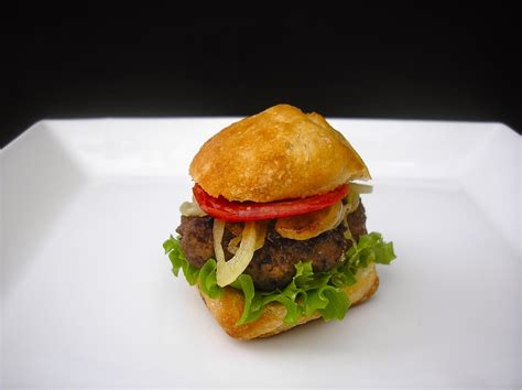 To prevent this, slightly depress the center of the patty to push a little extra meat toward the edges; food play: ' SAUDI SLIDER : HASHI ( CAMEL ) BURGER