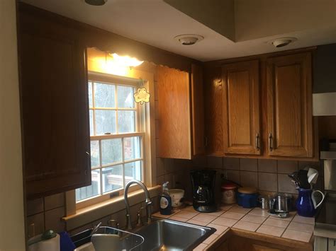 This is an older home built in 1930s that has a lowered ceiling from around the 50s. Consider removing lowered ceiling, taking out cupboards ...