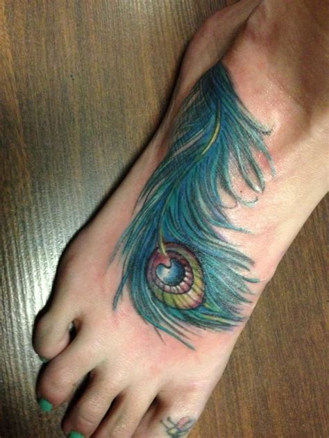 Here are some great examples of peacock theme tattoos. Peacock Feather Foot Tattoo Designs - CreativeFan