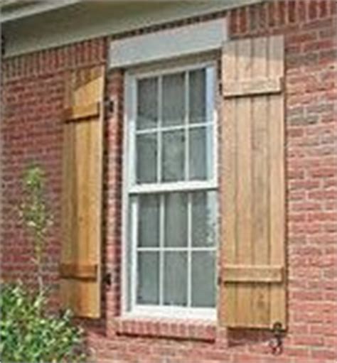 Wooden shutters on brick house. cedar shutters on red brick house | Red brick house, House ...