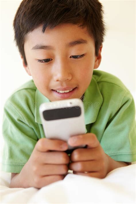 Young boy using smartphone stock image. Image of male - 55892245