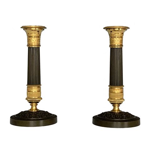 The console rises on caryatid legs from a raised plinth to a marble top. A Pair Of French Empire Ormolu & Bronze Candlesticks ...