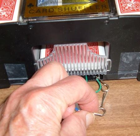 Desolder one side of the leads for the motors and feed them through the hole. How to Repair a Card Shuffler | ThriftyFun