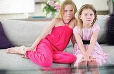 sisters sofa young two sitting portrait stock dissolve source d25