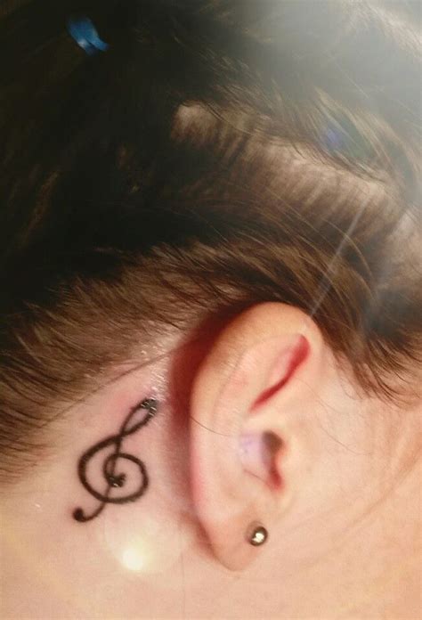 Feeling of fullness or clogging in the ear. Treble Clef behind ear. My first tattoo. Wasnt too painful ...