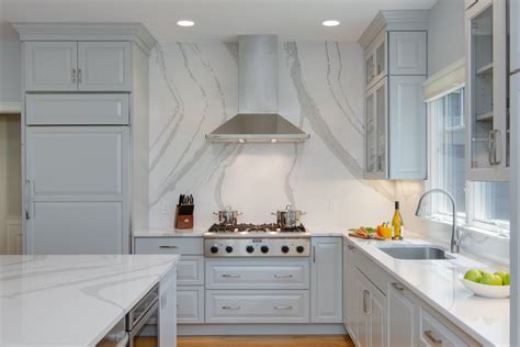 Some homeowners may prefer to choose their solid stone backsplash from a complementary color or pattern. Gray Transitional Kitchen With Full-Height Backsplash ...