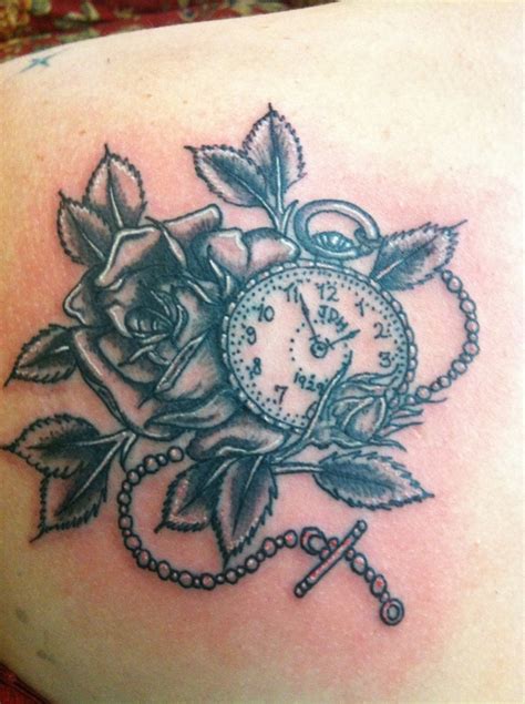 A pair of roses accent a pocket watch in this tattoo that is colored in a style reminiscent of oil paintings. Pocket watch and rose tattoo. My grandfathers initials and ...