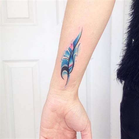 Awesome peacock feather tattoo on wrist. Watercolor feather tattoo on the left inner wrist.