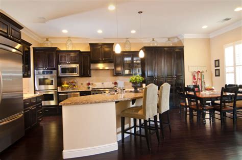 When installing cabinets first, you need to tell your cabinet makers/counter top installers of the clearance needed for the dishwasher with the extra added height of the floor. 34 Kitchens with Dark Wood Floors (Pictures)