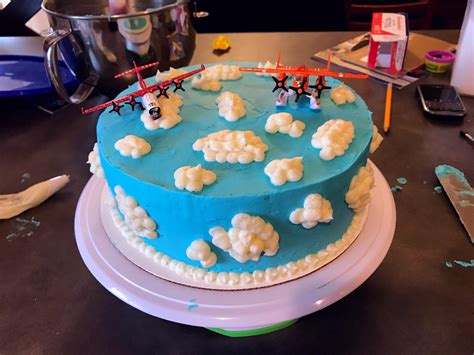 This airplane cake is extremely simple since it does not mess with creating an elaborate plane shaped cake. Homemade Airplane cake with buttercream clouds : food