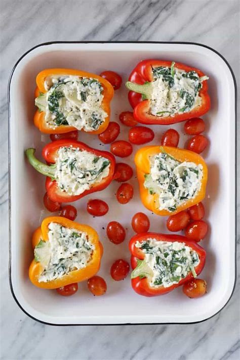 Bored with your basic stuffed peppers recipe ? An easy vegetarian stuffed peppers recipe made with ...